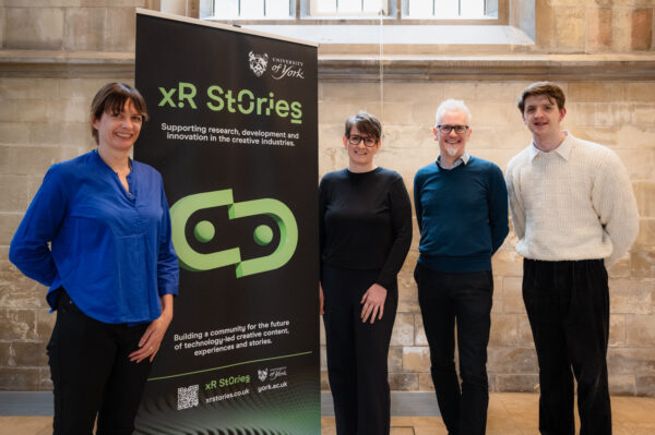 Emma Brown, Anthonia James, Damian Murphy and Jay Harrison stand next to an XR Stories banner in The Guildhall, York
